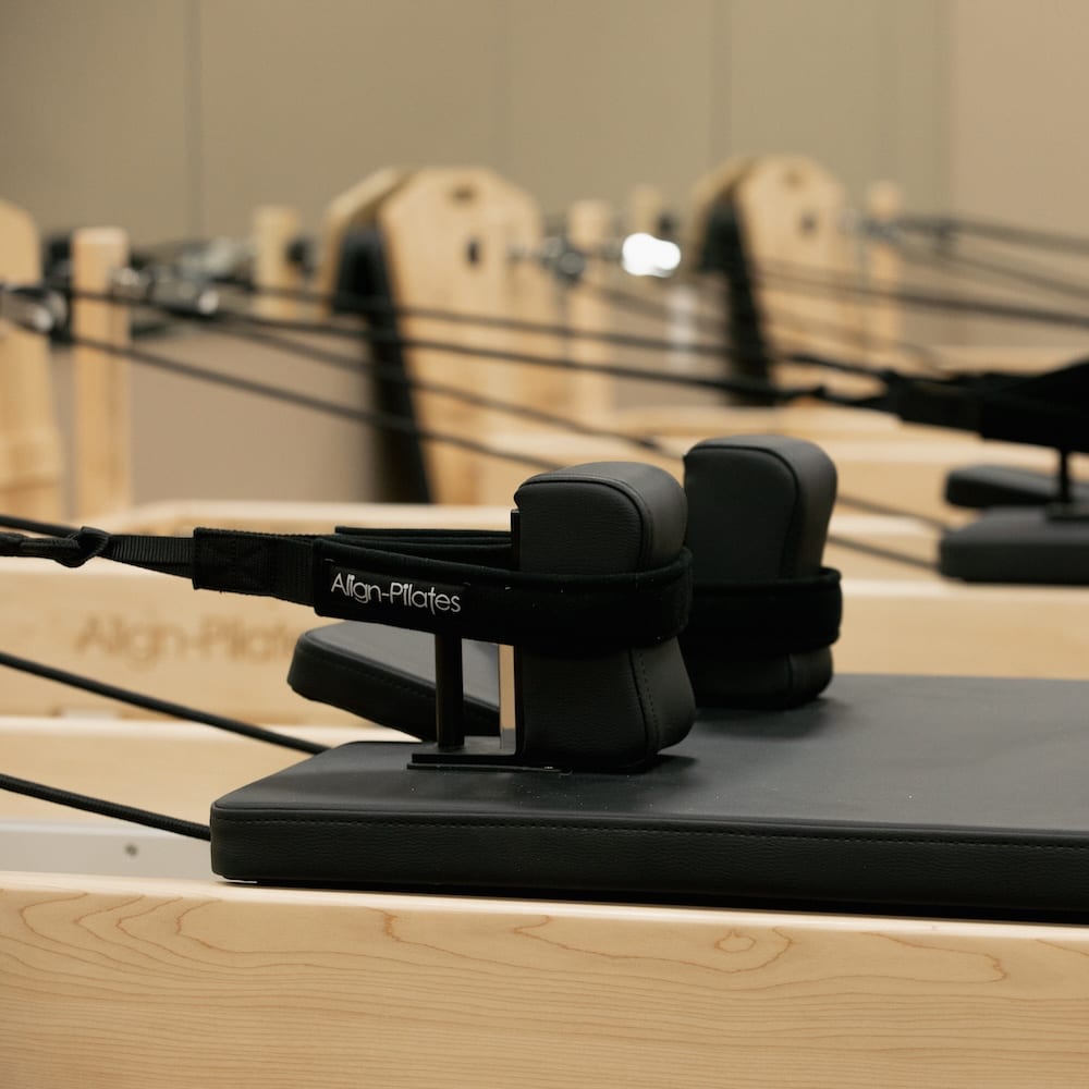 A reformer carriage and footstraps at Smart Pilates